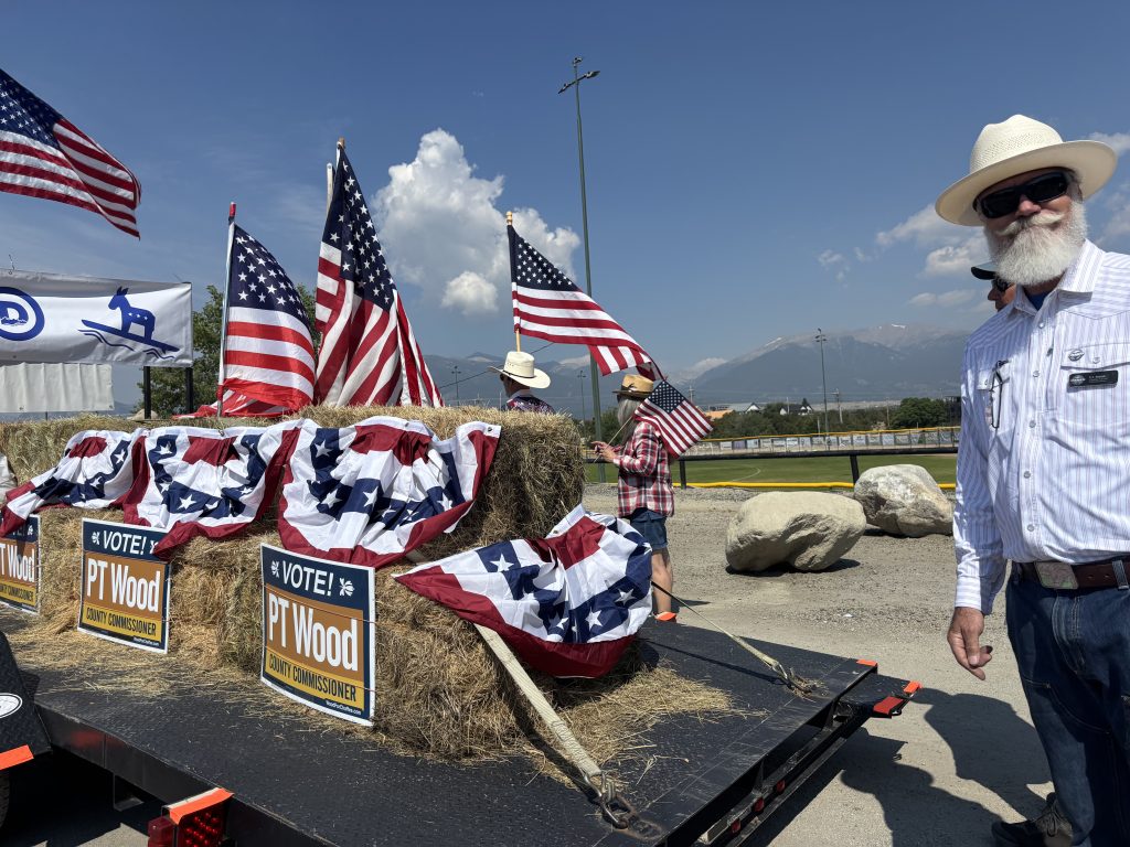 P.T Wood standing next to campaign signs
